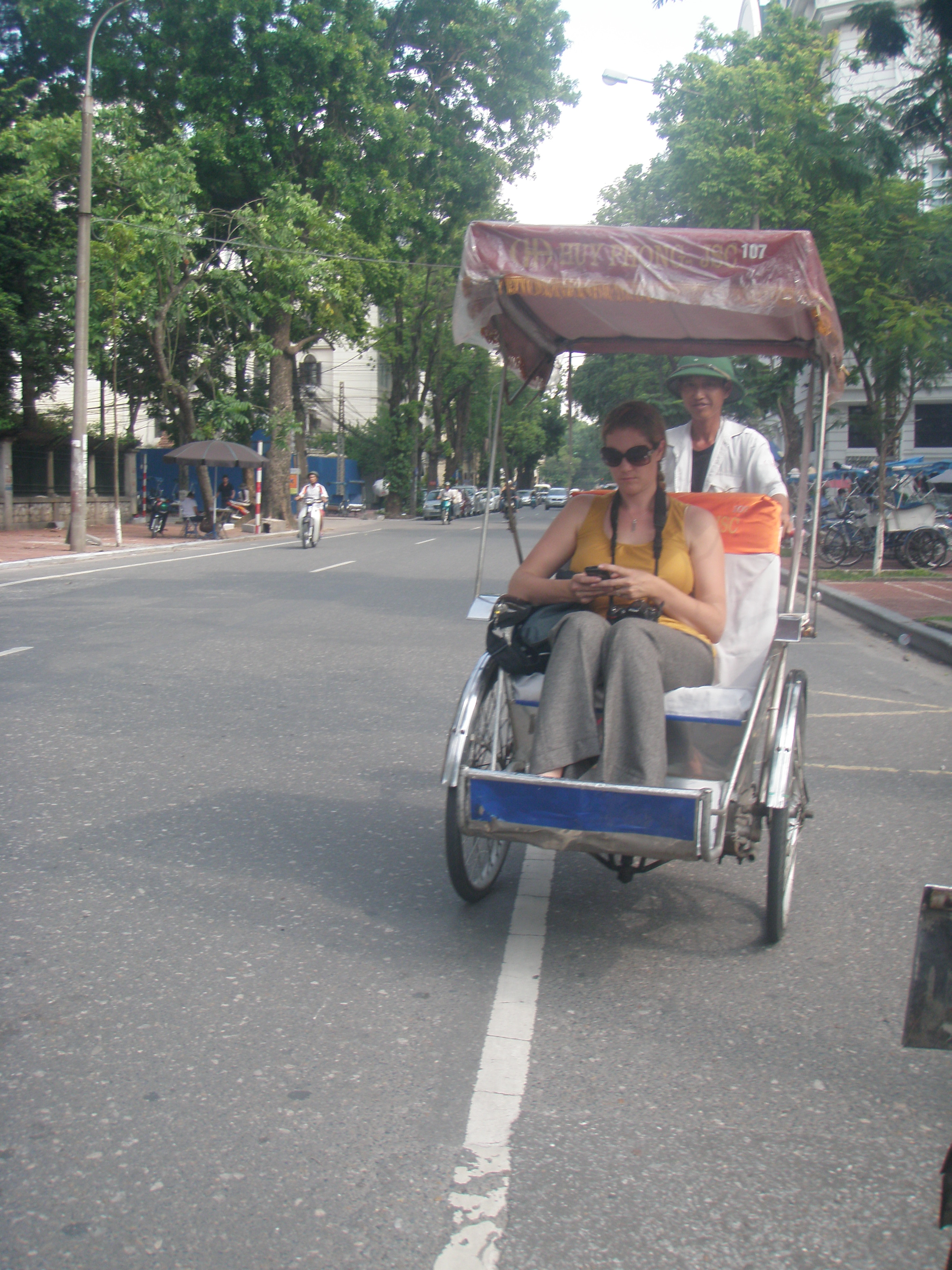 Hanoi1 Yep, Andrea really is checking her Blackberry while on a Cyclo tour in Hanoi.